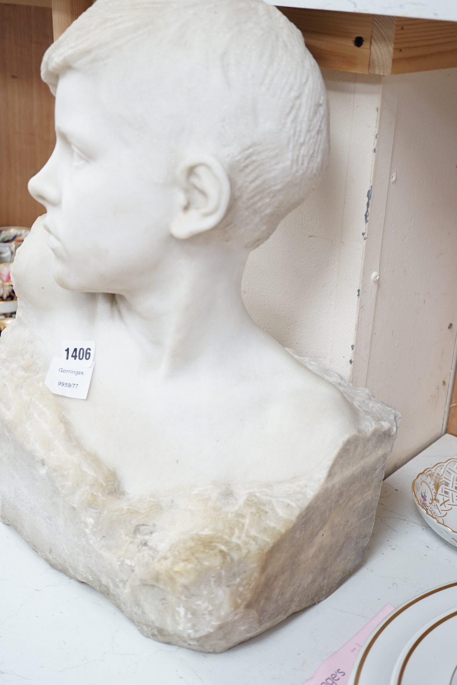 A carved Carrara marble portrait bust of a youth, unsigned, 46cm